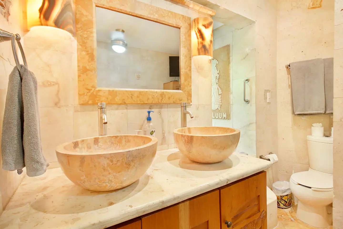 View from Condo 103’s balcony with tropical foliage and serene atmosphere