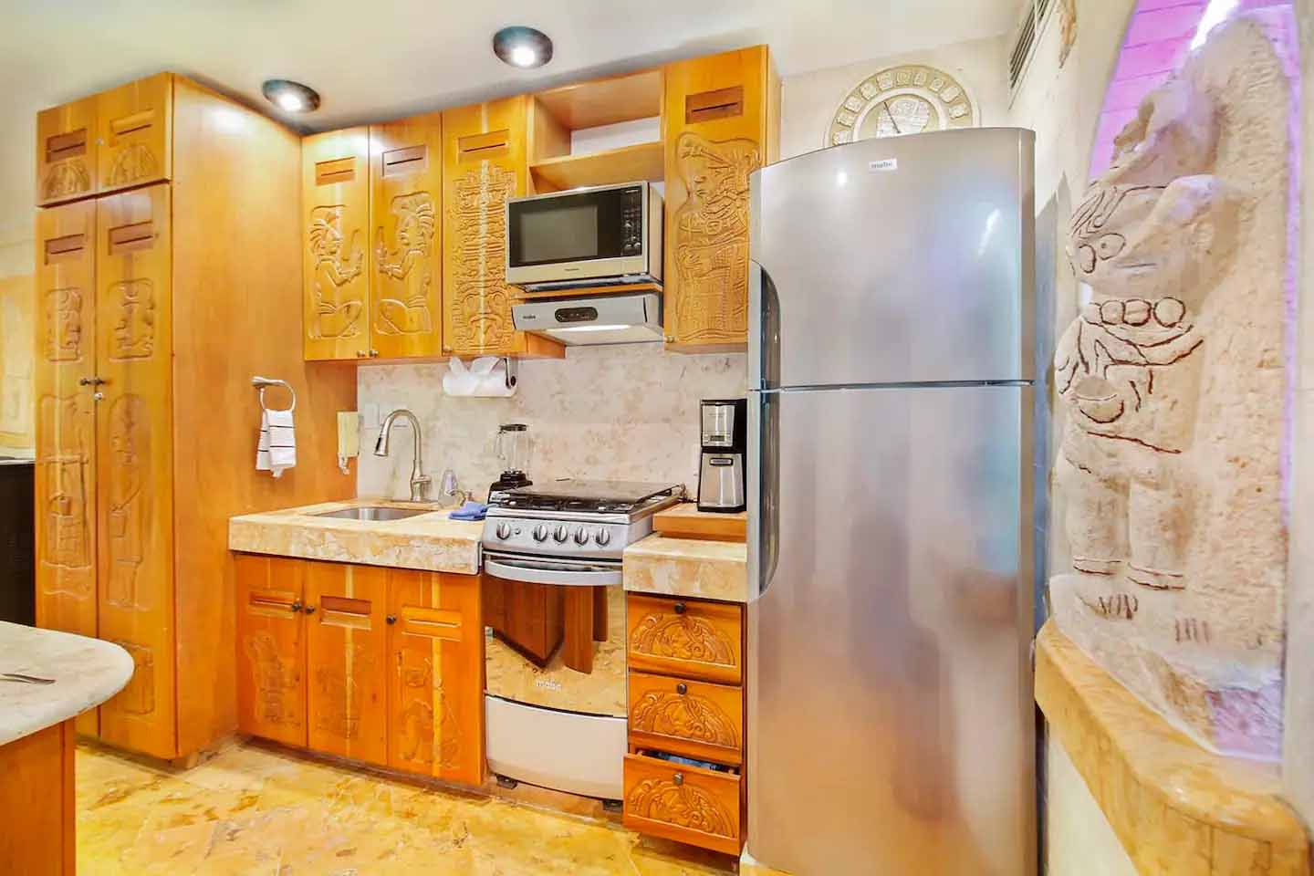 Elegant bedroom in Condo 103 featuring warm tones and ambient lighting